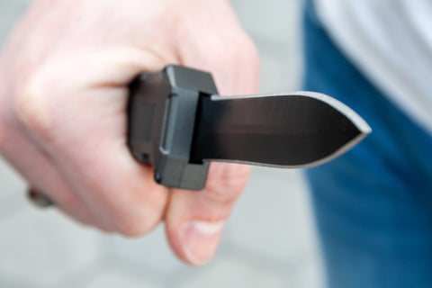 A wielded OTF knife