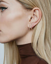 Diamond Huggie Hoops on model's ear