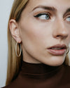 1" diamond hoops on model wearing brown top