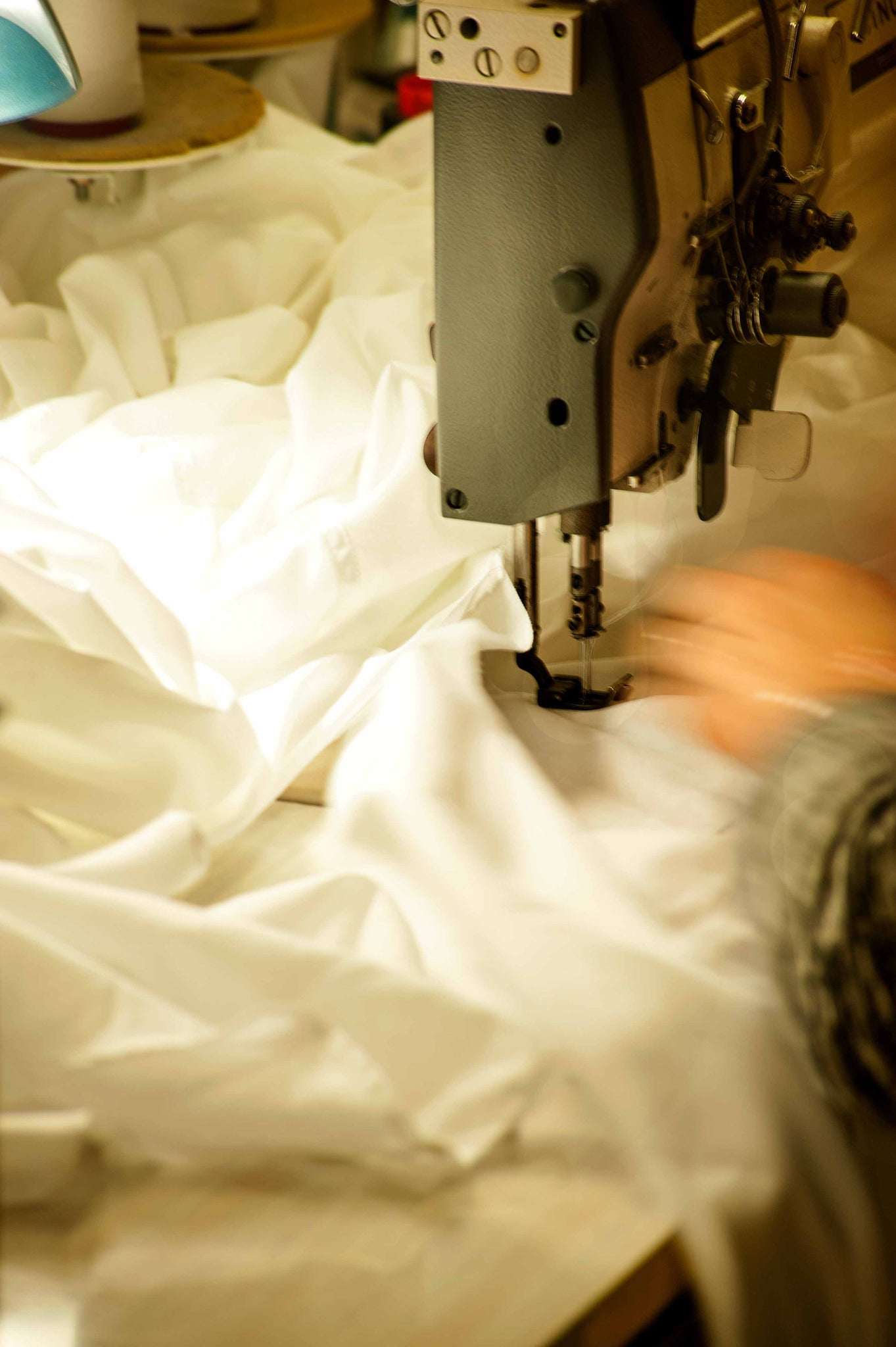 Photograph in maker's studio of fabric being sewn.