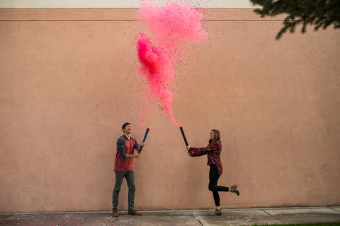 Couple Popping a Pink Mixed Powder And Confetti Cannon