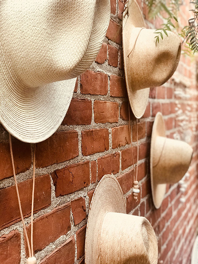 hats on a brick wall