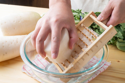 Grating daikon with bamboo grater