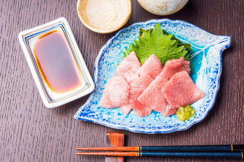 dipping sashimi in sweet soy sauce