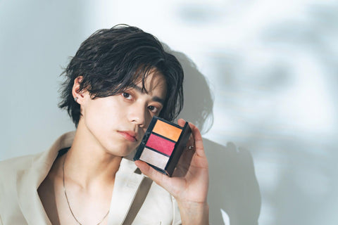 Japanese man using makeup