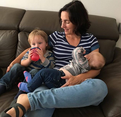 Mom nursing in Momzelle top while also cuddling toddler