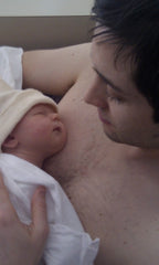 newborn baby skin to skin with father