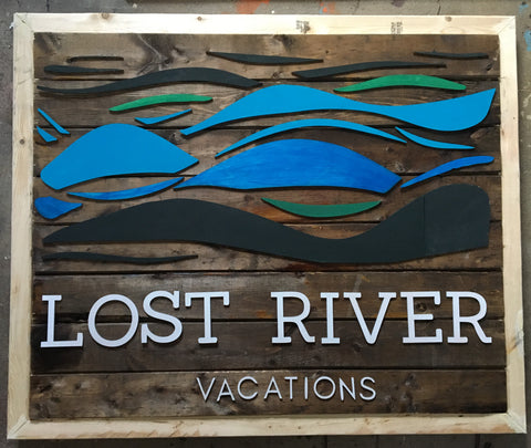 Wooden sign of Lost River Vacations and logo