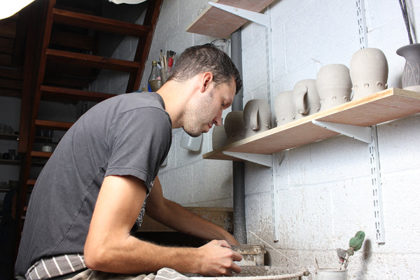 centering clay on the potters wheel