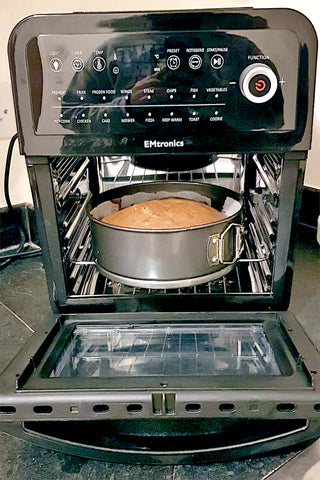 EMtronics Air Fryer with door open, showing a freshly baked cake