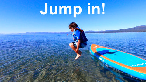 boy jumping in lake tahoe from his waterkids inflatable paddle board sup