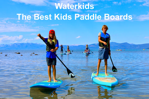 2 kids stand up paddle board on lake friends