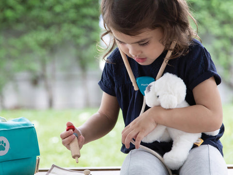 child role playing with doctors kit