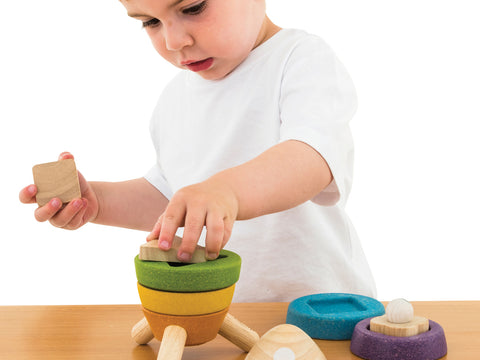 child playing with coloured blocks 
