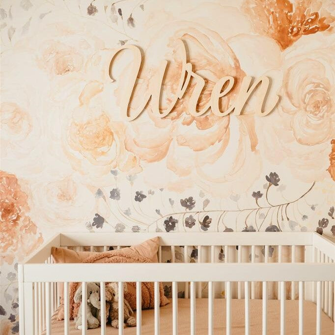 Peach floral wallpaper with baby name sign