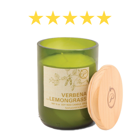 Candle in an 8 oz green glass vessel with a beige label and a wooden lid with 5 stars above the candle