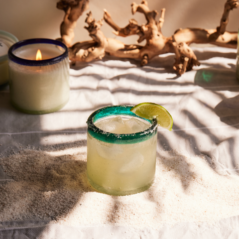 La Playa candle repurposed as a margarita glass with candle burning in the background