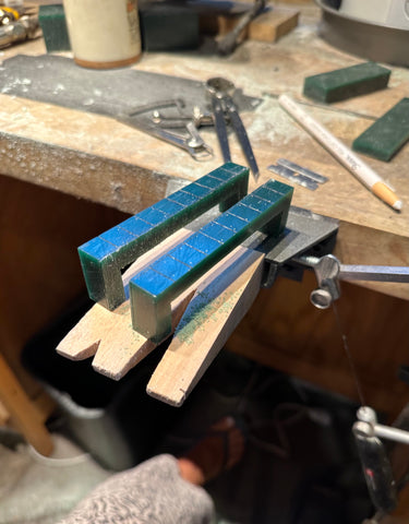 hand carved green wax for handles on a studio table