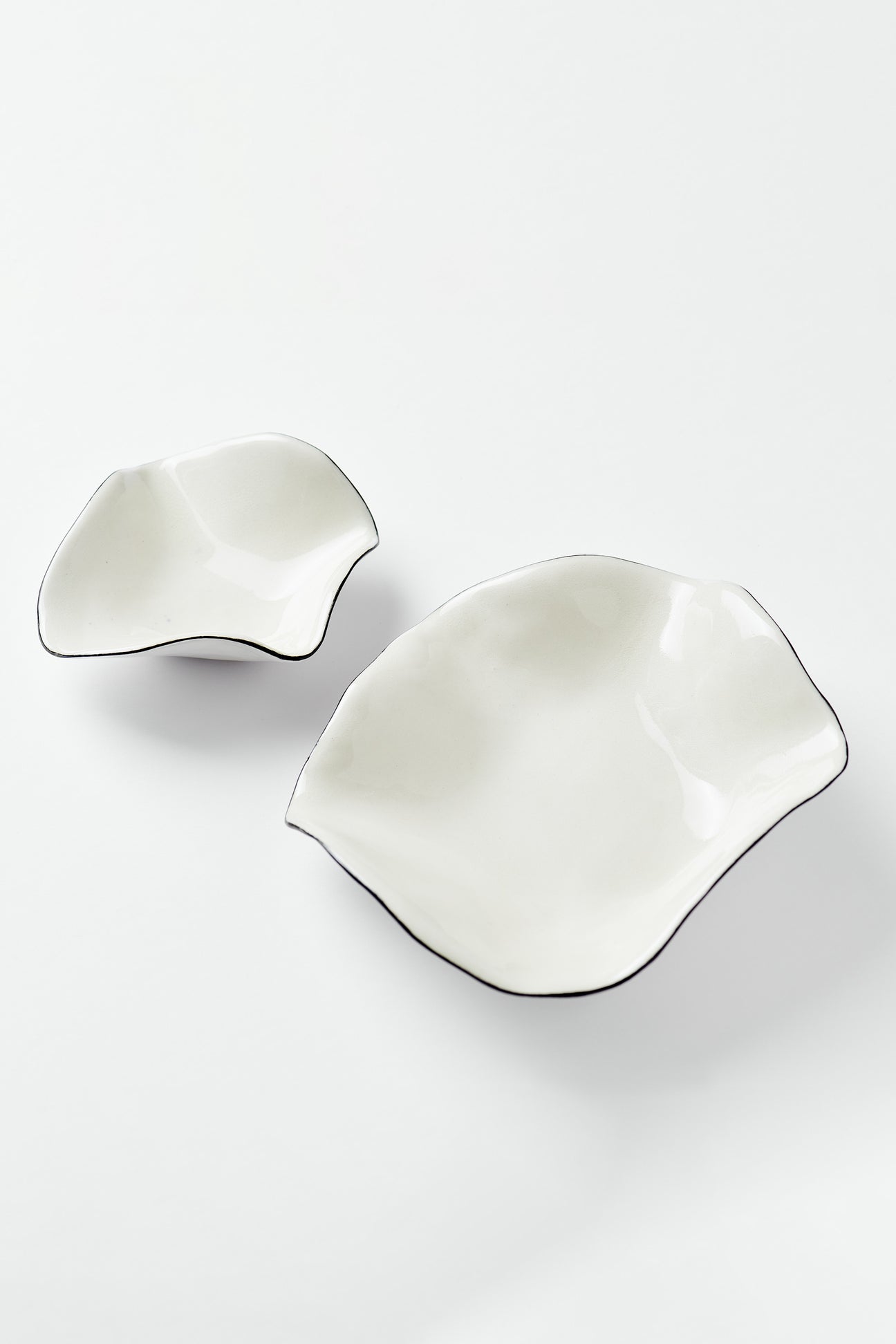 two ceramic catchalls on a white background