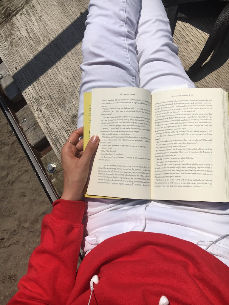 reading a book at the life guard station