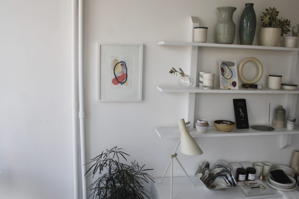an abstract study in a large white frame hanging on a wall 