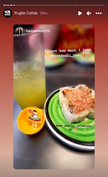 Instagram story showing a plate of sushi, cup of melon soda, and an opened yellow gachapon ball showing a Kura Sushi Puglie rubber bookmark.
