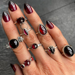 Different shaped garnet stone one-of-a-kind rings with red and black gothic nails