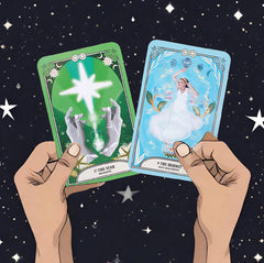 Two cards from the Crystal Magic Tarot deck (The star and the hermit) held up by hands against a background of stars in the night sky