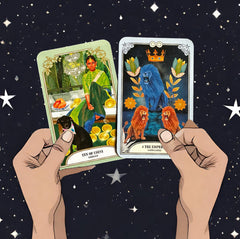 ten of coins and the emperor cards from he crystal magic tarot deck held up with two hands with a background of stars