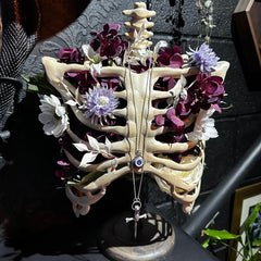 gothic necklace display skeletal ribcage filled with flowers used to hand gothic style necklaces