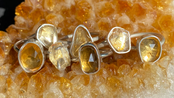 one of a kind citrine silver rings on a citrine cluster