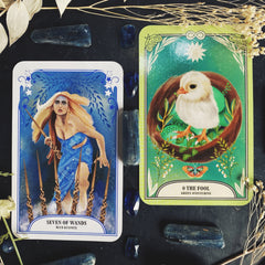 Seven of wands next to the fool, a baby chick, tarot cards