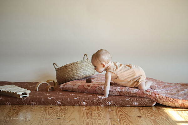 baby crawling on a toki mats play mat on the floor