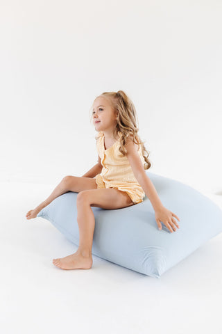 girl sitting on toki mats bean bags