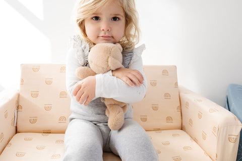 toddler sitting on a toki mats play couch