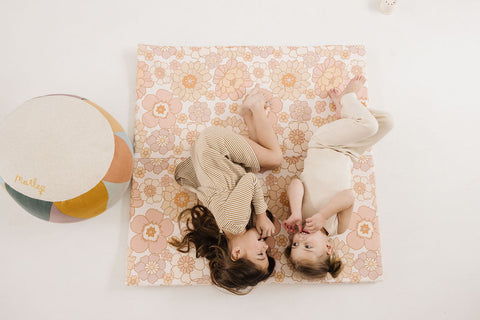 two kids laying on a vegan leather toki mat