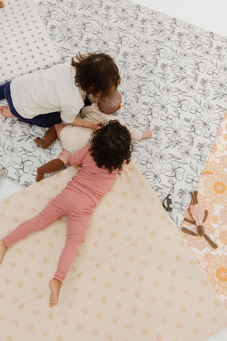 children laying on vegan leather toki mats