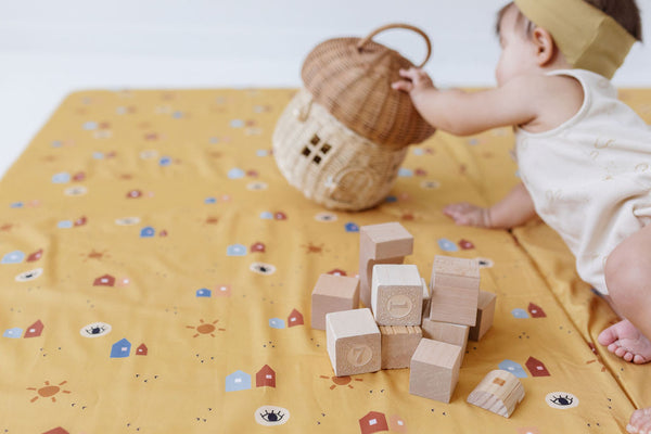 baby reaching for toy on toki mats play mat