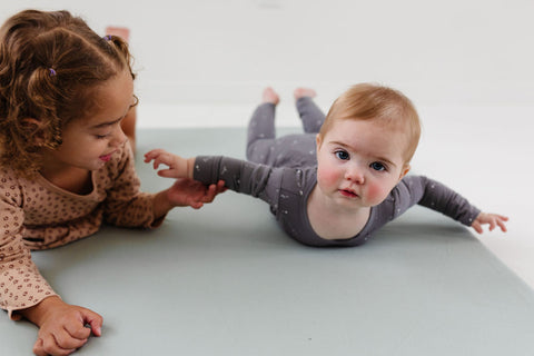 baby and toddler playing on a toki mats play mat