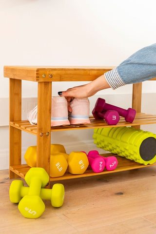 hand getting a shoe from a shoe rack with lifting bells