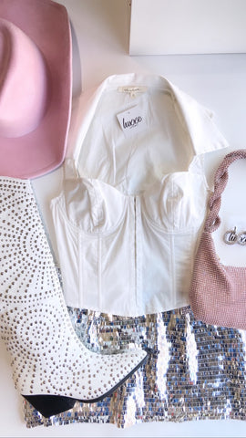 white corset top and sparkly silver skirt