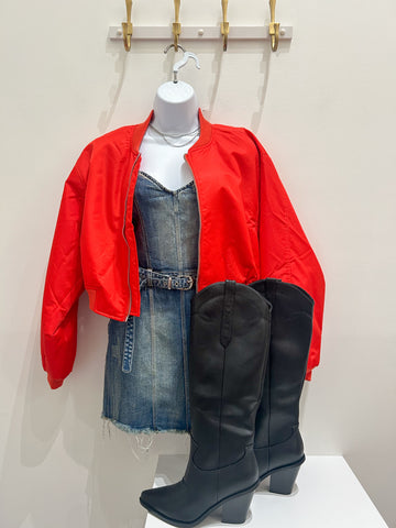 Denim mini dress with a red bomber jacket and black boots