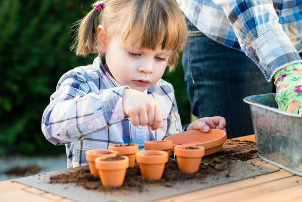 Child planting seeds for Ostara