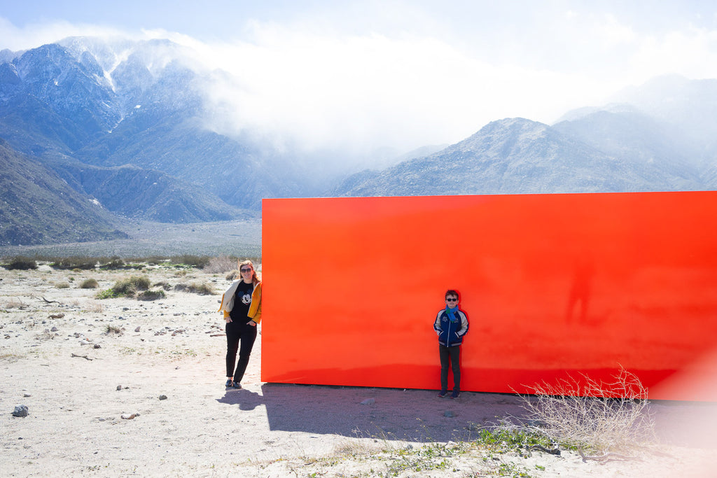 sterling ruby specter orange block in desert x19 two people standing with sand storm Palm Springs