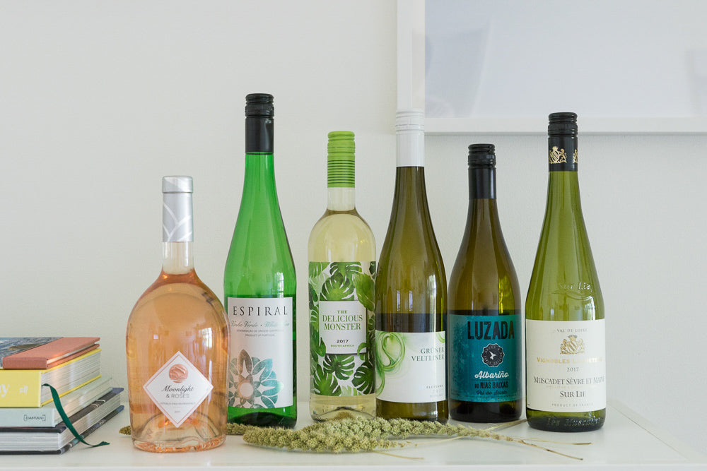 white wine and rose wine bottles on shelf