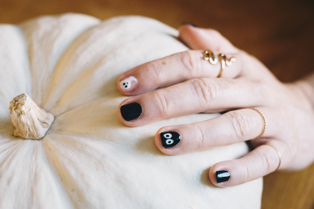 Janna Conner hallloween nail art hand on white pumpkin