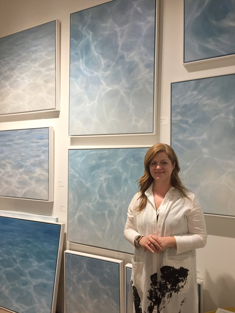 Laura Browning artist standing with water paintings at the Other art fair at the majestic downtown LA