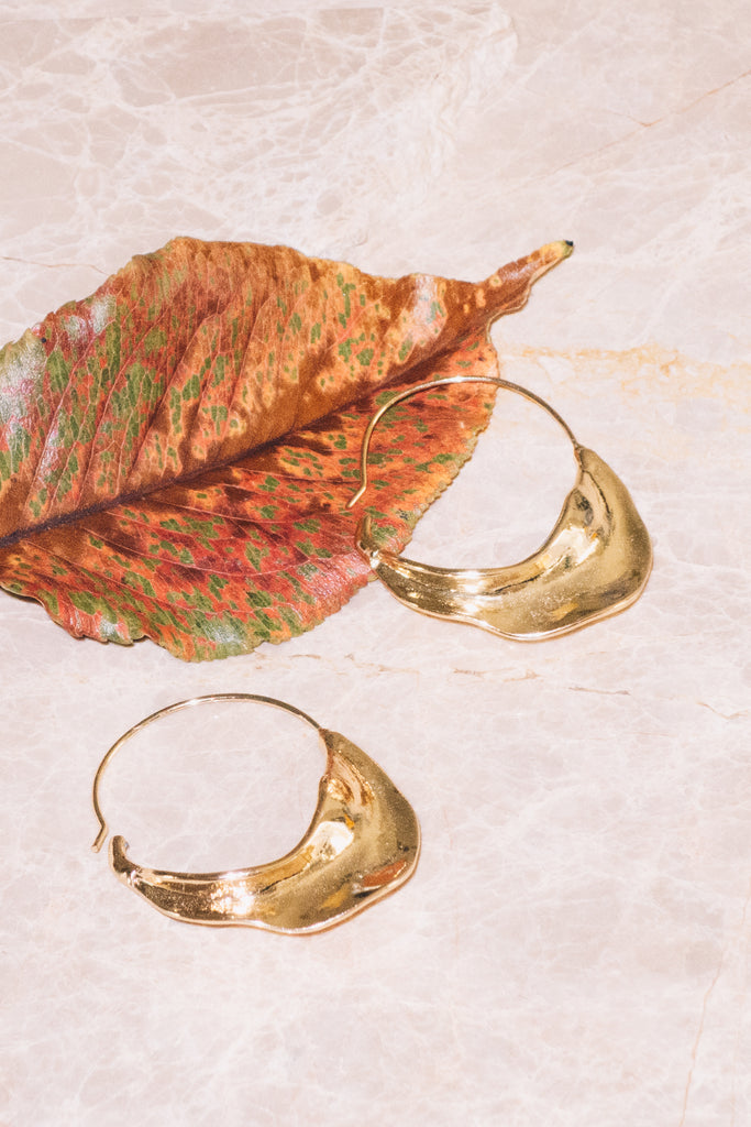 gold organic shape hoop earrings with fall leaf