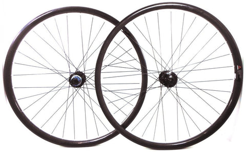 Photo of Light Bicycle Carbon MTB rims built onto Hope Evo and Tune Kong hubs by XLR8 wheels. Shows both wheels.
