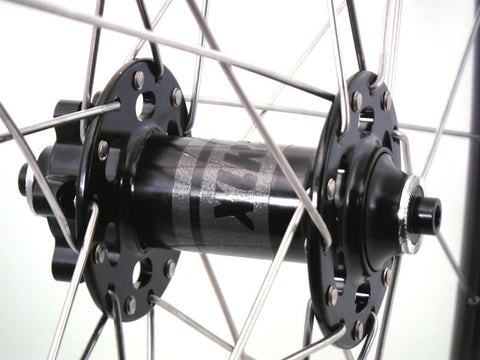 Picture of custom handmade gravel grinder or CX wheels using DT Swiss and XLR8 hubs with Rouleur rims. Front hub pictured.